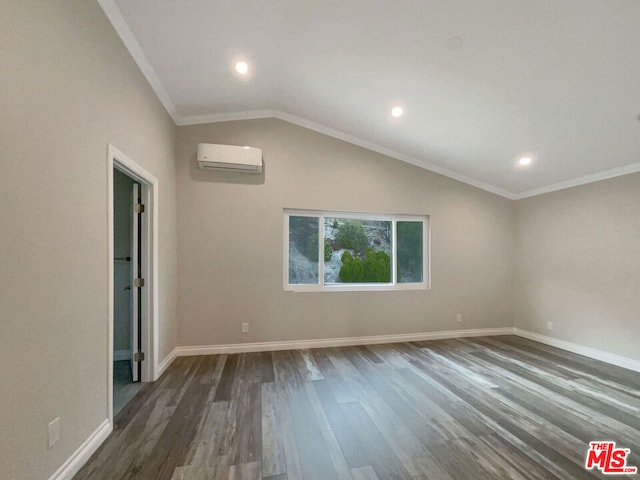 empty room with an AC wall unit, dark wood-type flooring, vaulted ceiling, and ornamental molding