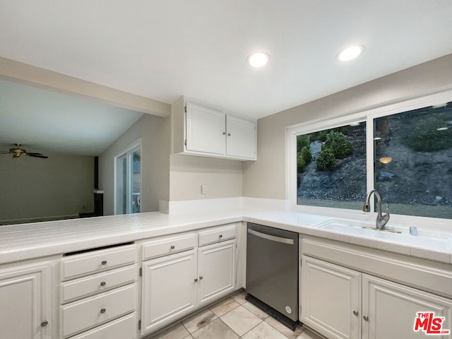 kitchen featuring ceiling fan, sink, dishwasher, white cabinetry, and lofted ceiling