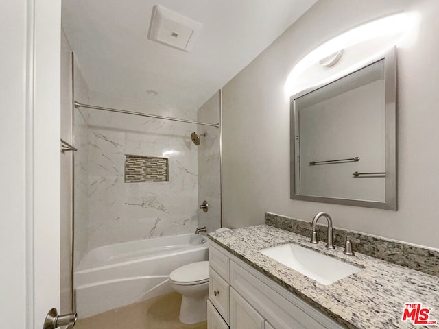 full bathroom featuring tiled shower / bath combo, toilet, and vanity