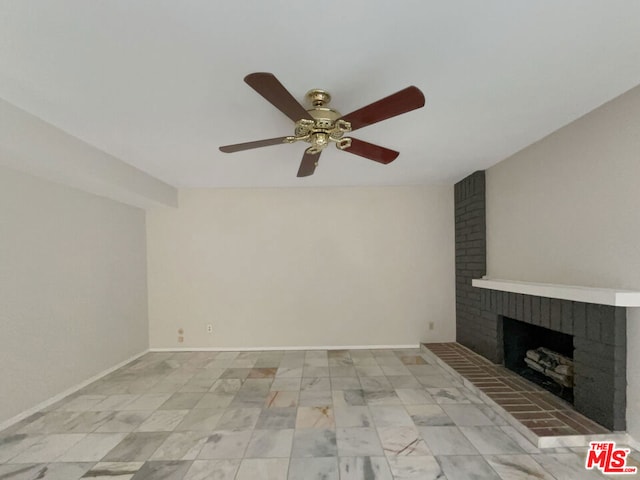 unfurnished living room with ceiling fan and a brick fireplace