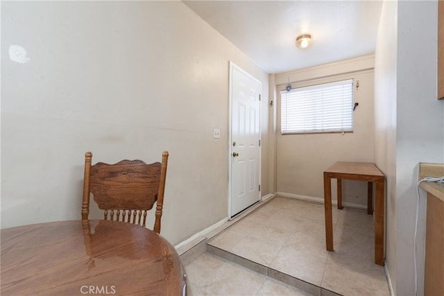 doorway to outside with light tile patterned flooring