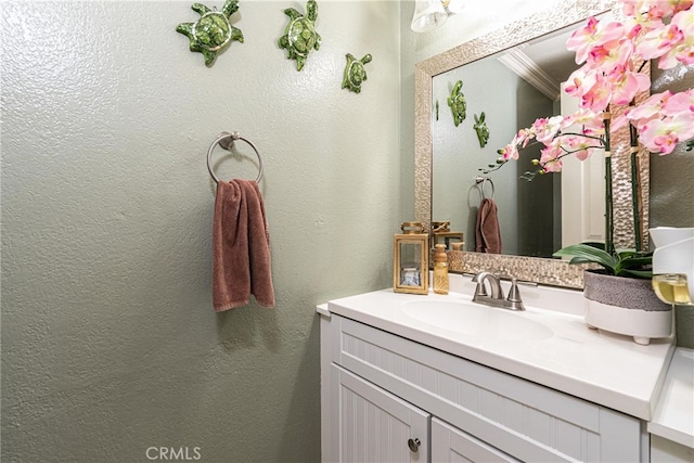 bathroom with vanity and crown molding