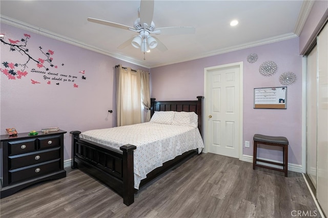 bedroom with ceiling fan, ornamental molding, and dark wood-type flooring