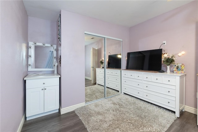 bedroom featuring dark hardwood / wood-style floors and a closet