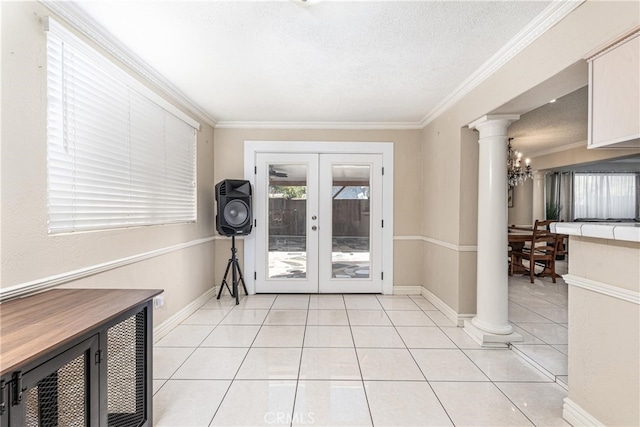 doorway with an inviting chandelier, light tile patterned floors, crown molding, and french doors