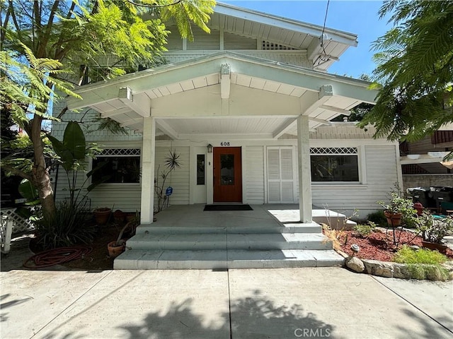 view of exterior entry with covered porch