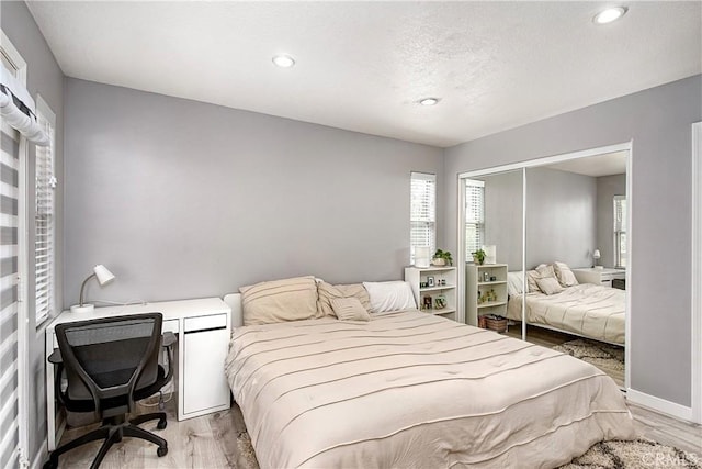 bedroom featuring light hardwood / wood-style floors and a closet