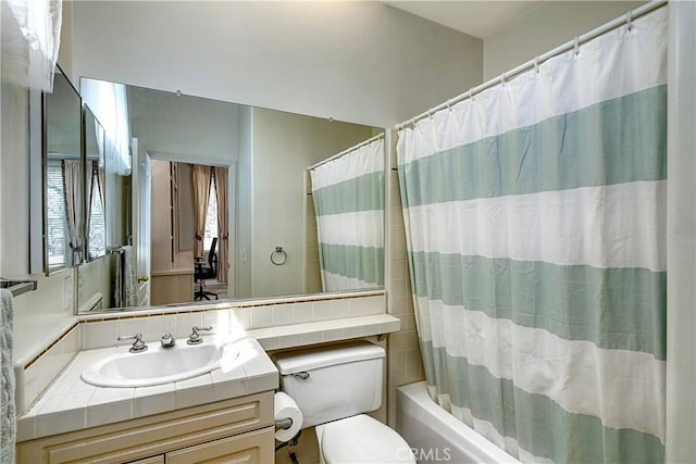 full bathroom with vanity, toilet, and shower / tub combo with curtain