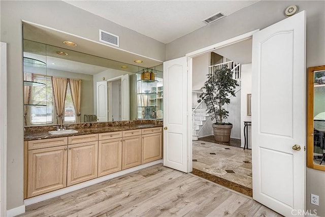 bathroom with vanity and hardwood / wood-style flooring