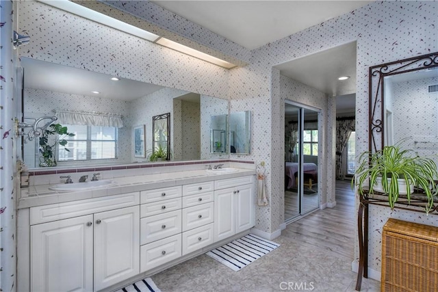 bathroom with vanity and wood-type flooring