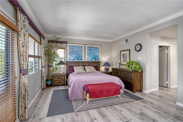 bedroom with light wood-type flooring, multiple windows, and crown molding