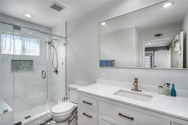 bathroom with vanity, toilet, and walk in shower