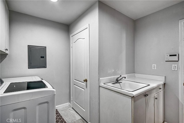 clothes washing area featuring electric panel, sink, cabinets, and independent washer and dryer