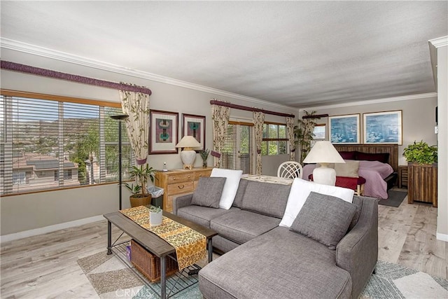 living room with crown molding, plenty of natural light, and light wood-type flooring