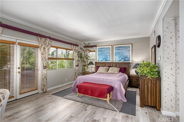 bedroom featuring access to exterior, crown molding, and light hardwood / wood-style flooring