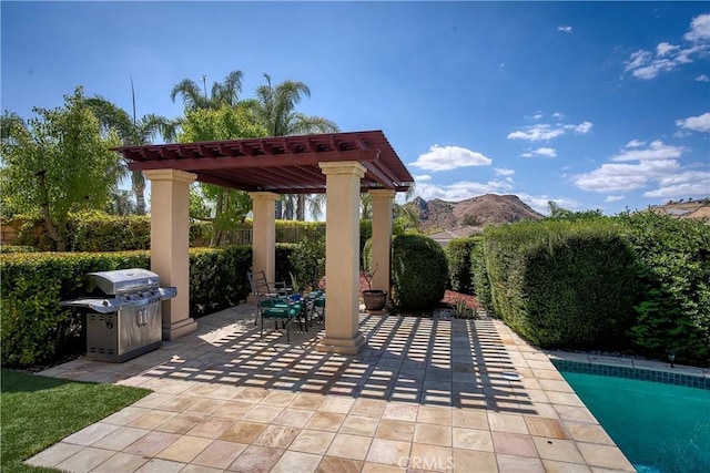 view of patio with a pergola, a grill, and a mountain view