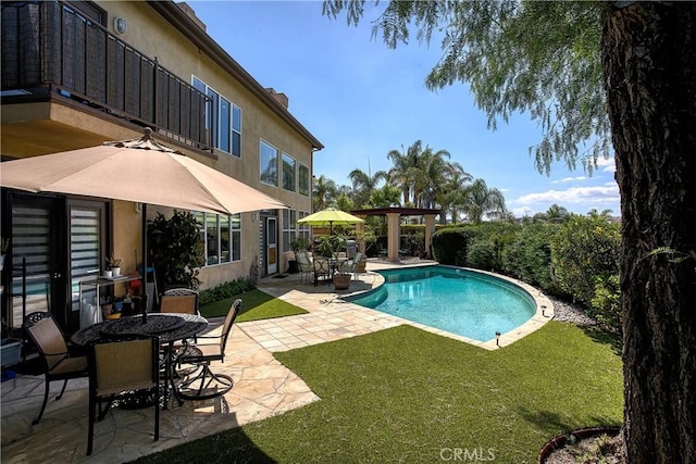 view of pool featuring a lawn and a patio area