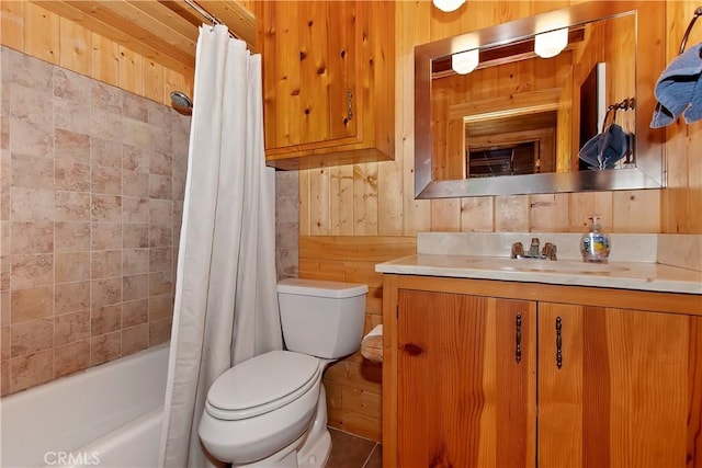 bathroom with wooden walls, vanity, shower / bathtub combination with curtain, and toilet