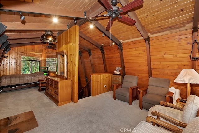 sitting room featuring light carpet, wood ceiling, wood walls, and rail lighting