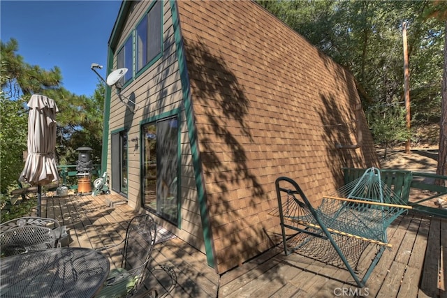 view of property exterior featuring a wooden deck