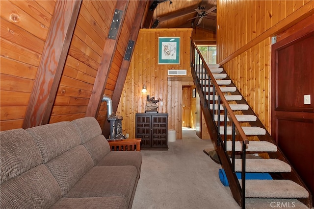 living room with carpet, wooden ceiling, ceiling fan, vaulted ceiling with beams, and wooden walls