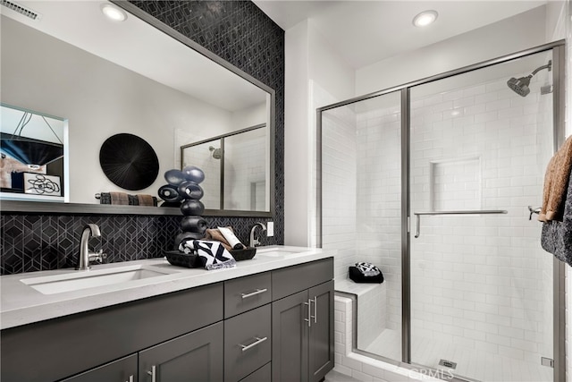 bathroom with walk in shower, backsplash, and vanity