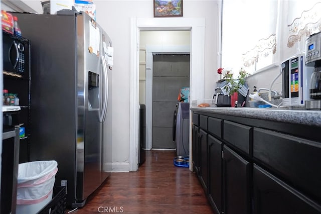 kitchen with dark wood-type flooring and stainless steel fridge with ice dispenser