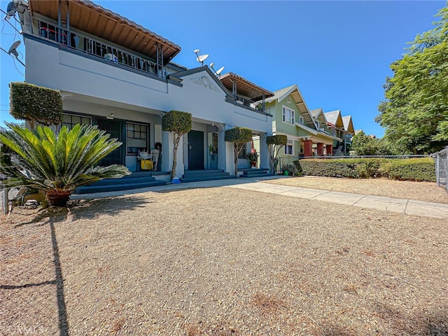 view of front of house featuring a balcony and a porch