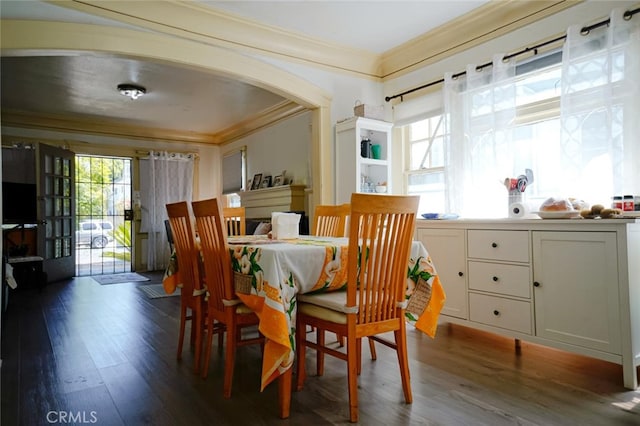 dining room featuring dark hardwood / wood-style floors and crown molding