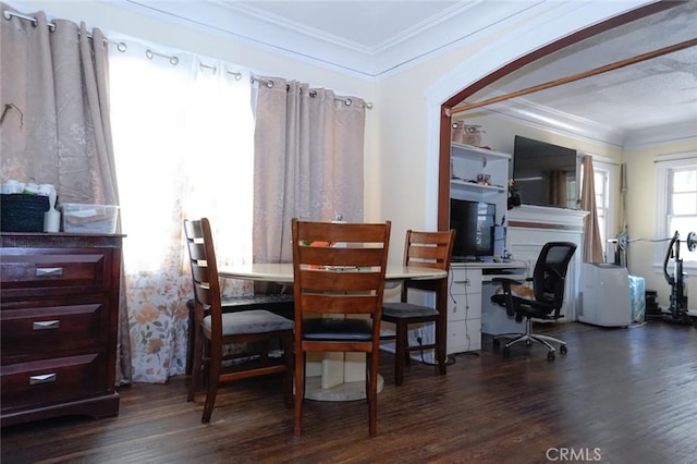 dining space featuring crown molding and dark hardwood / wood-style flooring