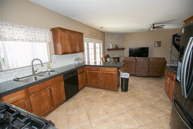 kitchen featuring tasteful backsplash, kitchen peninsula, dishwasher, stainless steel refrigerator with ice dispenser, and sink