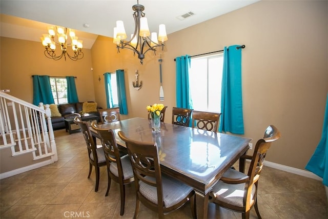 dining room with an inviting chandelier and tile patterned flooring