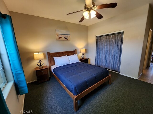 bedroom featuring dark carpet and ceiling fan