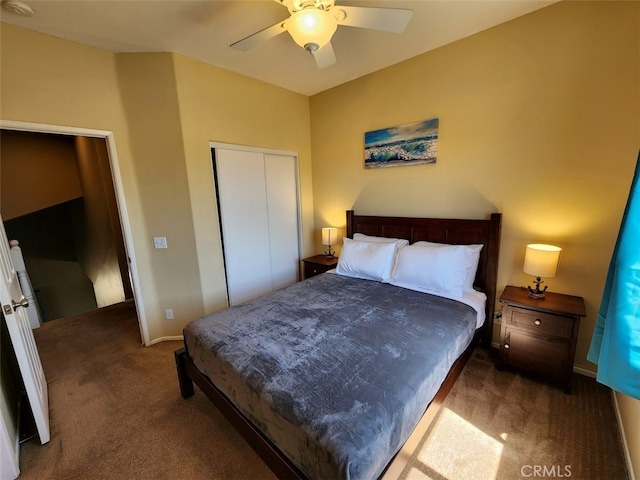 bedroom with ceiling fan, a closet, and dark colored carpet