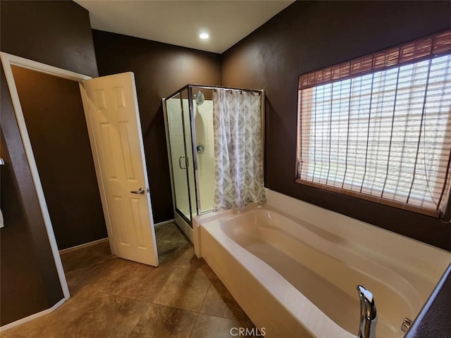 bathroom featuring plus walk in shower and tile patterned flooring