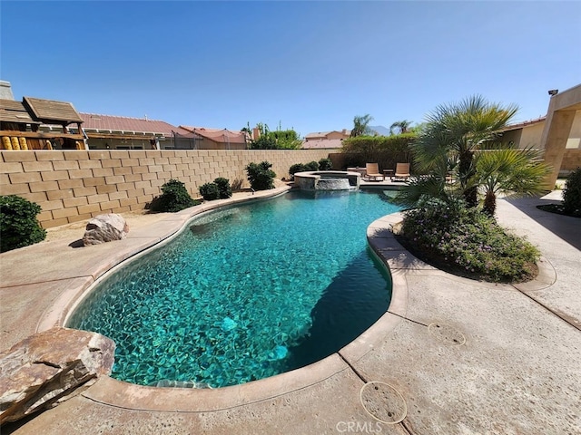 view of swimming pool featuring a patio and an in ground hot tub