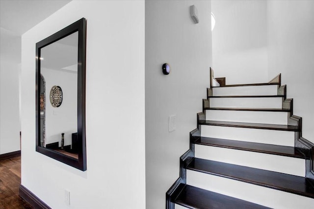 stairway with hardwood / wood-style floors