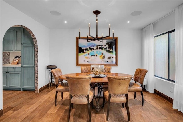 dining room featuring light hardwood / wood-style floors and a notable chandelier