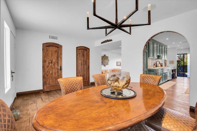 dining space featuring sink and light hardwood / wood-style flooring