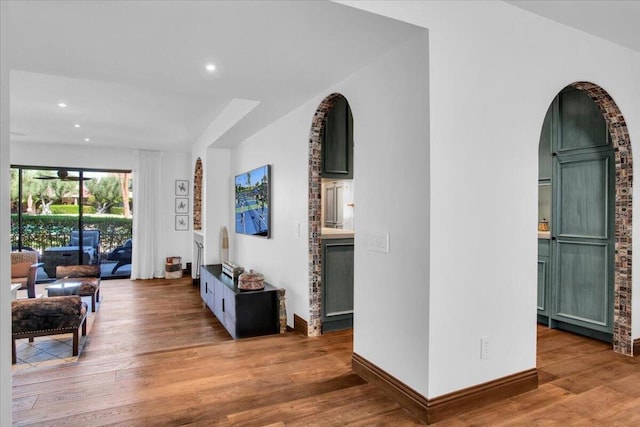 corridor with hardwood / wood-style floors