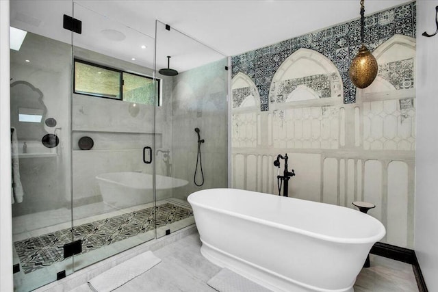 bathroom featuring shower with separate bathtub