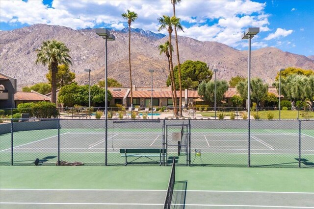 view of tennis court featuring a mountain view