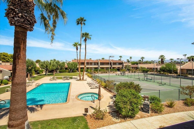 view of pool featuring tennis court and a community hot tub