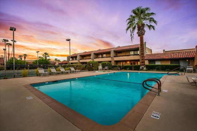 view of pool at dusk