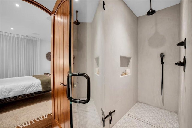 bathroom featuring a shower with door