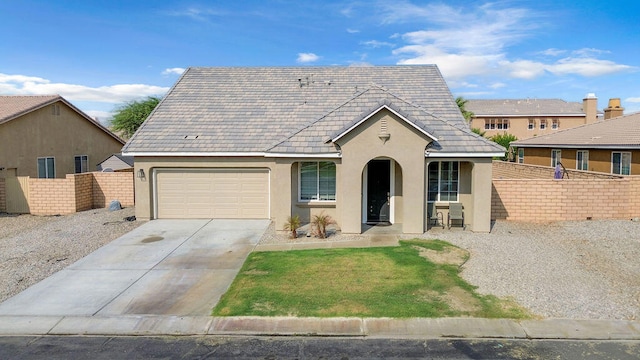 view of front of home with a garage and a front lawn