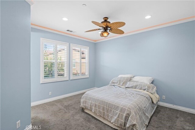 bedroom with carpet floors, crown molding, and ceiling fan