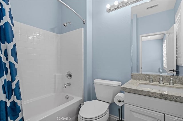 full bathroom with shower / tub combo with curtain, vanity, and toilet