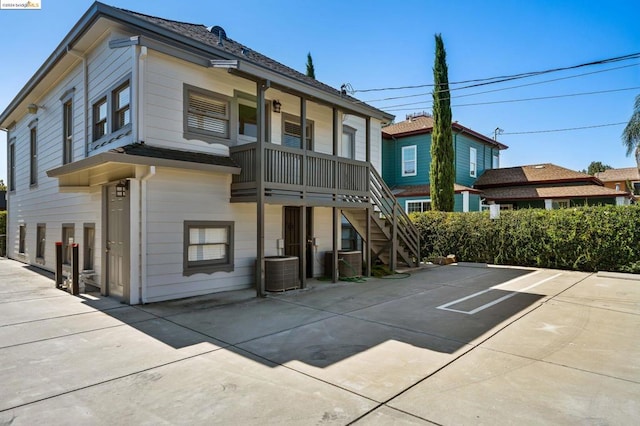 rear view of property featuring cooling unit