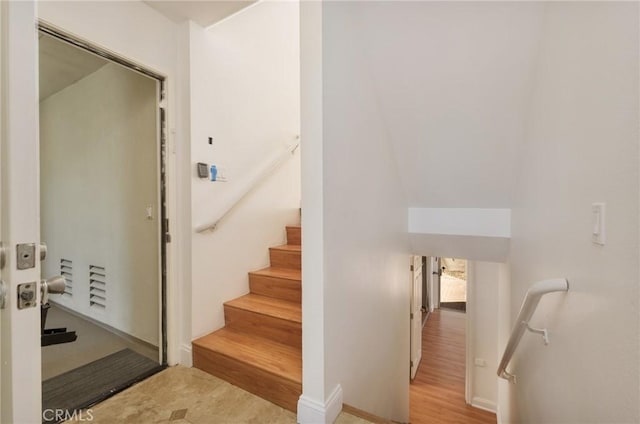 stairs with wood-type flooring